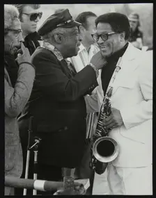 Count Basie chatting with Illinois Jacquet at the Capital Radio Jazz Festival, London, July 1979. Co Creator: Denis Williams