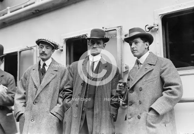 Count de Lesseps, G. Curtiss, and H. Latham standing on train platform, 1910. Creator: Bain News Service.