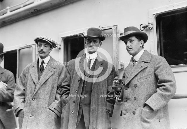 Count de Lesseps, G. Curtiss, and H. Latham standing on train platform, 1910. Creator: Bain News Service.