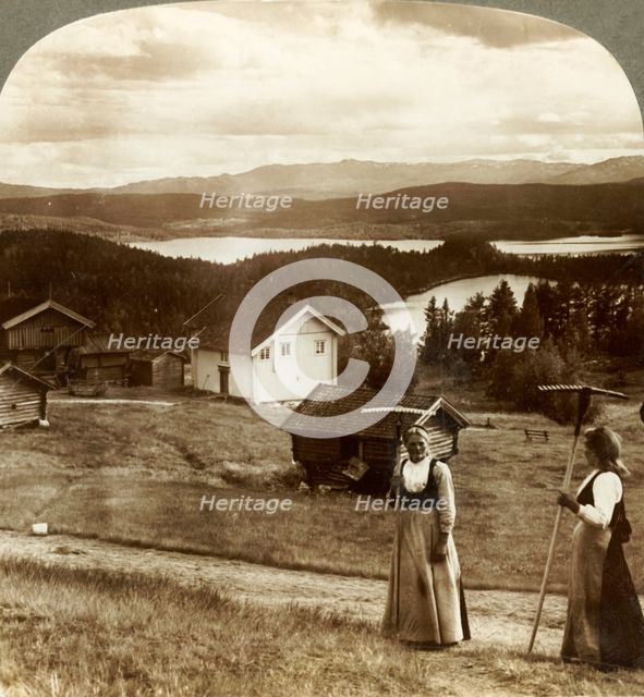 'Country girls in haying time - over Bolkesjo and Folsjo (lakes) to Himingen Mts., Norway', c1905.  Creator: Unknown.
