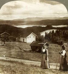 Country girls in haying time - over Bolkesjo and Folsjo (lakes) to Himingen Mts., Norway c1905. Creator: Unknown