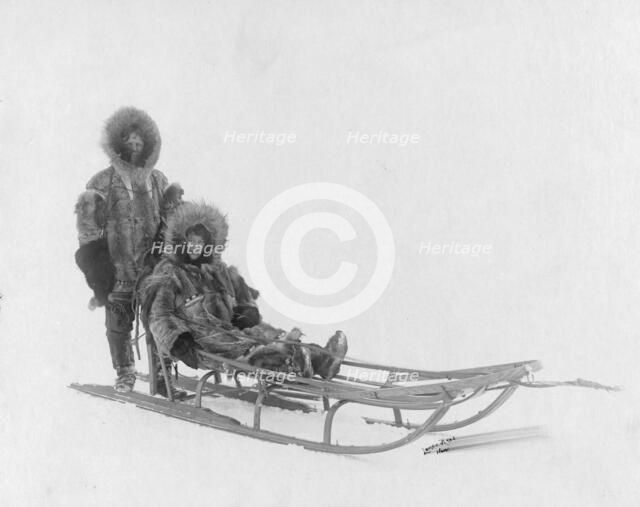 Couple on dog sled, between c1900 and 1927. Creator: Lomen Brothers.