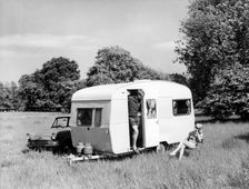 Couple on holiday with their 1963 Sprite Alpine caravan, (c1963?)