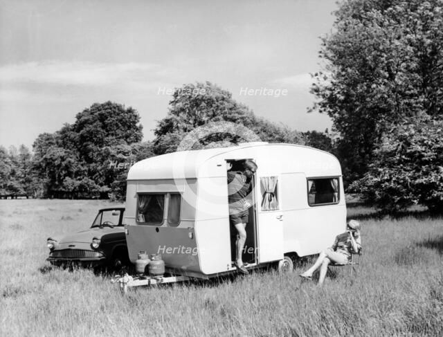 Couple on holiday with their 1963 Sprite Alpine caravan, (c1963?). Artist: Unknown