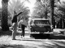 Couple with a 1955 Chevrolet Townsman station wagon, (c1955?)