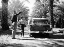 Couple with a 1955 Chevrolet Townsman station wagon, (c1955?)