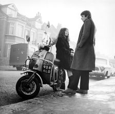 Couple with a scooter, London, 1967. Creator: Henry Grant