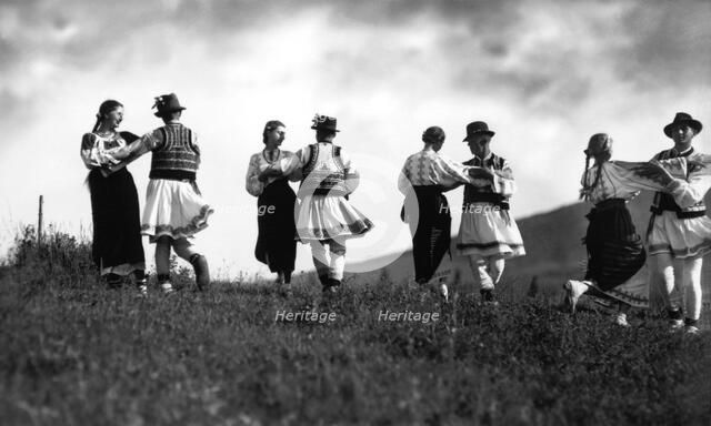 Couples in traditional dress dancing, Bistrita Valley, Moldavia, north-east Romania, c1920-c1945. Artist: Adolph Chevalier