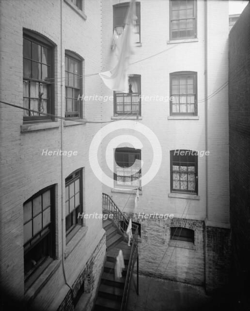 Court of tenement, New York City, between 1900 and 1910. Creator: Unknown.