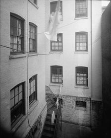 Court of tenement, New York City, between 1900 and 1910. Creator: Unknown