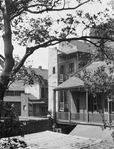 Courtyard balconies and upper levels of houses, New Orleans, between 1920 and 1926. Creator: Arnold Genthe