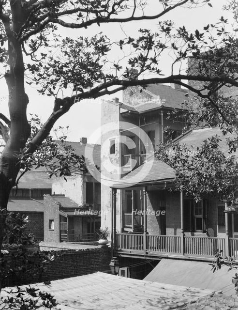 Courtyard balconies and upper levels of houses, New Orleans, between 1920 and 1926. Creator: Arnold Genthe.