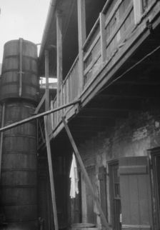 Courtyard with cistern, New Orleans, between 1920 and 1926. Creator: Arnold Genthe