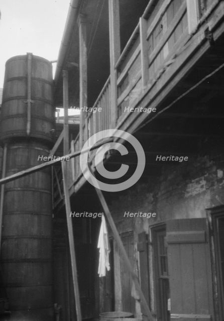 Courtyard with cistern, New Orleans, between 1920 and 1926. Creator: Arnold Genthe.