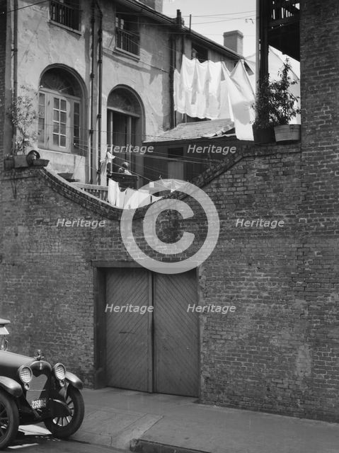 Courtyard with a garage, New Orleans, between 1920 and 1926. Creator: Arnold Genthe.