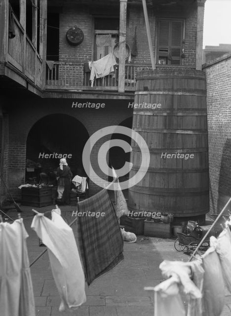 Courtyard with hanging laundry, New Orleans, between 1920 and 1926. Creator: Arnold Genthe.