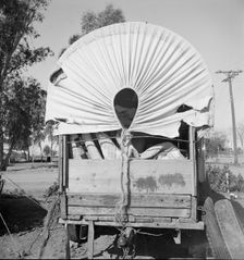 Covered wagon, migratory carrot puller's camp, near Holtville, Imperial Valley, 1939. Creator: Dorothea Lange