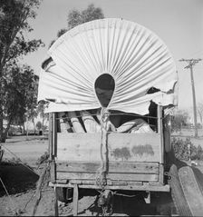 Covered wagon, migratory carrot puller's camp, near Holtville, Imperial Valley, 1939. Creator: Dorothea Lange