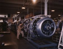 Cowling and control rods are added to motors for...North American Inc., Inglewood, Calif., 1942. Creator: Alfred T Palmer