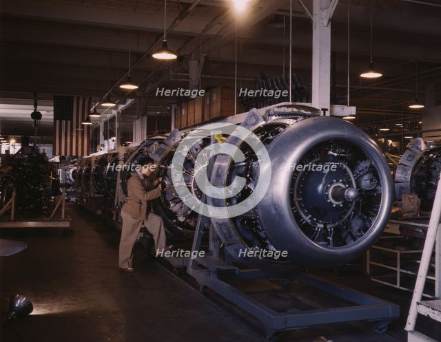 Cowling and control rods are added to motors for...North American Inc., Inglewood, Calif., 1942. Creator: Alfred T Palmer.