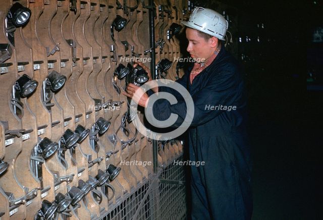 Coal miner collecting his lamp.