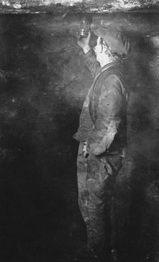 Coal Mining, Fireman searching for Gas postcard, c1900s. Creator: Unknown