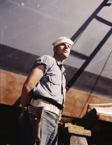 Coast Guardsman standing watch over 78-foot torpedo..., Higgins Industries, Inc., New Orleans, 1942. Creator: Howard Hollem