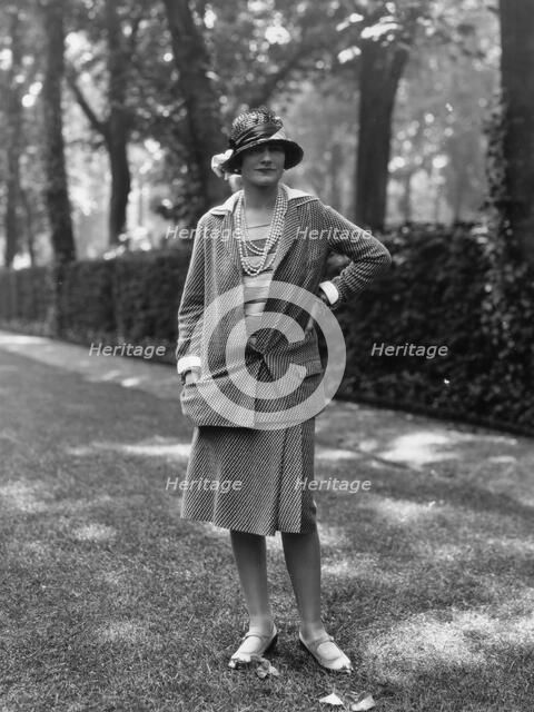 Coco Chanel modeling a Chanel suit on rue Faubourg Saint-Honoré in Paris, 1929, 1929. Creator: Sasha; (Alexander Stewart) (1892-1953).