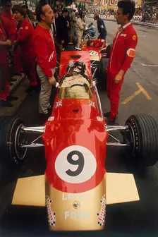 Colin Chapman and a mechanic in discussion over Graham Hill's Lotus, Monaco Grand Prix, 1969