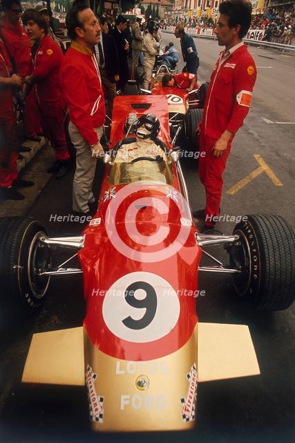 Colin Chapman and a mechanic in discussion over Graham Hill's Lotus, Monaco Grand Prix, 1969. Artist: Unknown