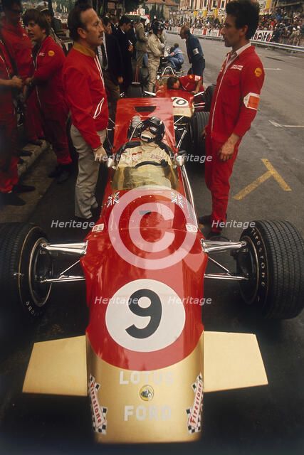 Colin Chapman and a mechanic in discussion over Graham Hill's Lotus, Monaco Grand Prix, 1969. Artist: Unknown