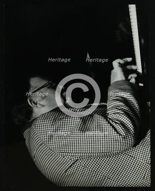 Colin Bates on the piano at The Stables, Wavendon, Buckinghamshire. Creator: Denis Williams.