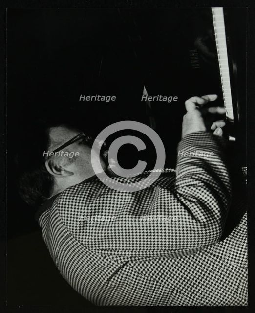 Colin Bates on the piano at The Stables, Wavendon, Buckinghamshire. Creator: Denis Williams.