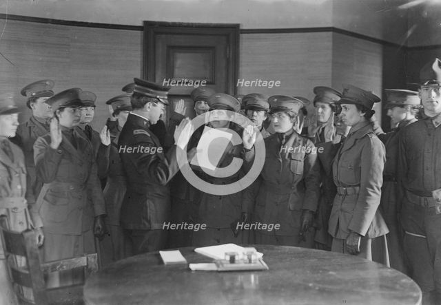 Colonel J.H. Wells swearing in woman motorist, 29 May 1917. Creator: Bain News Service.