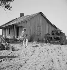 Colored tractor driver and empty cabin, Aldridge Plantation near Leland, Mississippi, 1937. Creator: Dorothea Lange