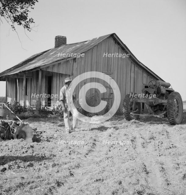 Colored tractor driver and empty cabin, Aldridge Plantation near Leland, Mississippi, 1937. Creator: Dorothea Lange.