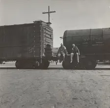 Colored itinerants on oil tank cars passing through Kingsbury, California, 1938. Creators: Farm Security Administration, Dorothea Lange