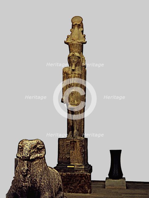 Colossal statue of Sethi II carrying a divine emblem, made in sandstone, from the Temple of Amon …