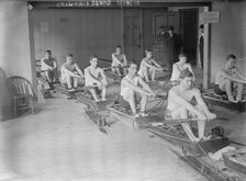 Columbia crew team in mock shells practicing in club house, 1910. Creator: Bain News Service