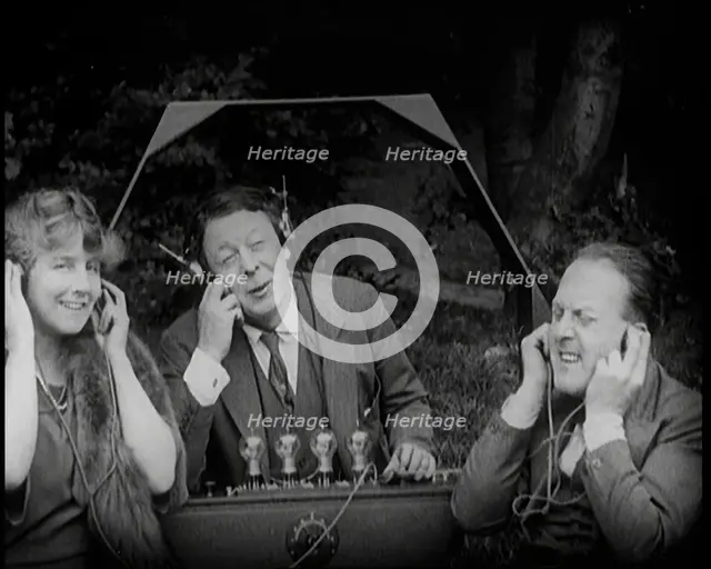 Comedian Harry Tate Sitting With One Female Civilian and One Male Civilian Listening to The..., 1924 Creator: British Pathe Ltd.