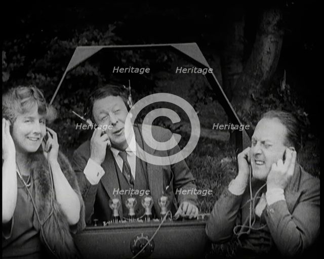 Comedian Harry Tate Sitting With One Female Civilian and One Male Civilian Listening to The..., 1924 Creator: British Pathe Ltd.