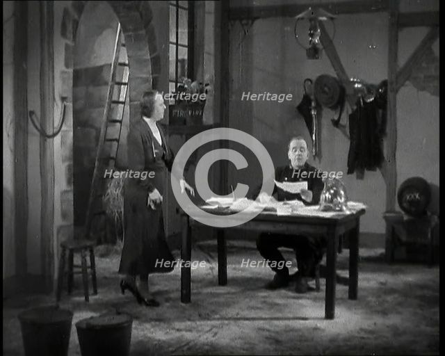 Comedian Robb Wilton On Set Playing a Fire Brigade Officer and Sitting at a Desk With Papers...,1938 Creator: British Pathe Ltd.