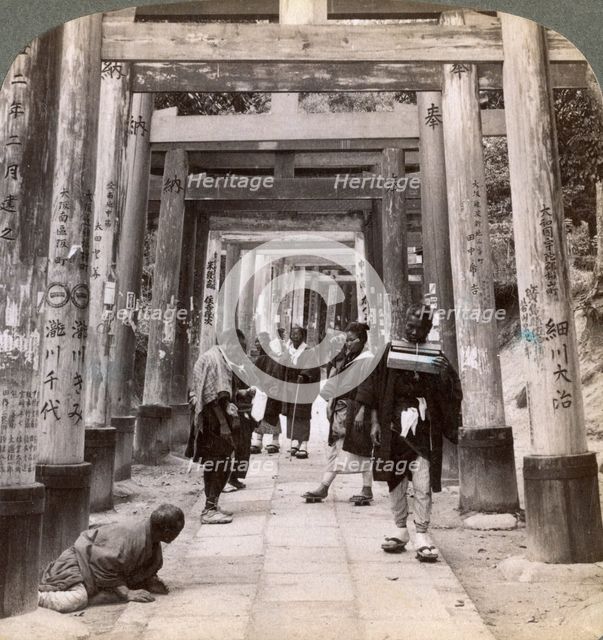 Coming and going under long rows of sacred torii, Shinto temple of Inari, Kyoto, Japan, 1904. Artist: Underwood & Underwood