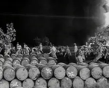 Commonwealth Troops Walking Through a Flaming Supply Dump, 1941. Creator: British Pathe Ltd