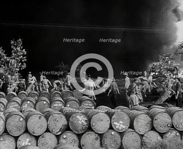 Commonwealth Troops Walking Through a Flaming Supply Dump, 1941. Creator: British Pathe Ltd.