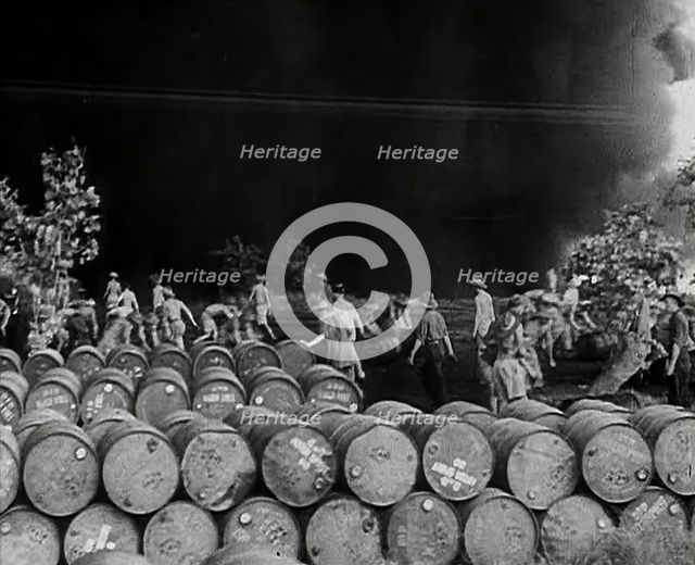 Commonwealth Troops Walking Through a Flaming Supply Dump, 1941. Creator: British Pathe Ltd.