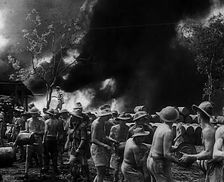Commonwealth Troops Watching Flames and Smoke Emitting from a Supply Dump, 1941. Creator: British Pathe Ltd