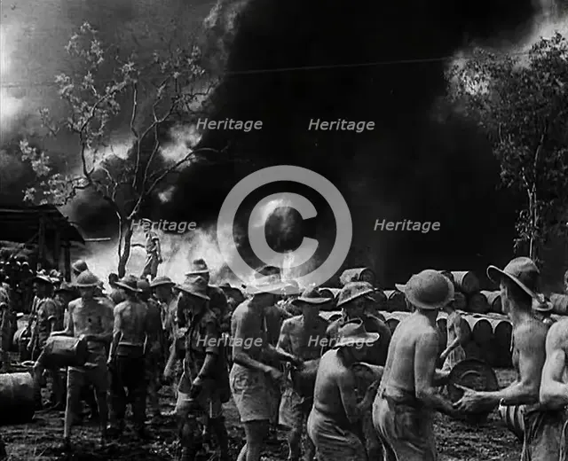 Commonwealth Troops Watching Flames and Smoke Emitting from a Supply Dump, 1941. Creator: British Pathe Ltd.