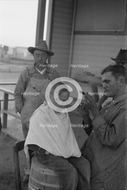Community barber shop in Kern County migrant camp, California, 1936. Creator: Dorothea Lange.
