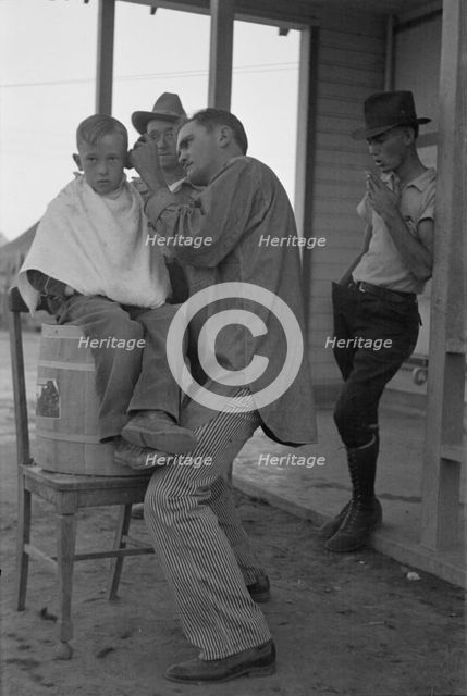 Community barber shop in Kern County migrant camp, California, 1936. Creator: Dorothea Lange.